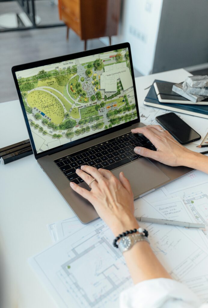 pexels-photo-5292203-5292203 Architect working on landscape plan displayed on laptop with hands typing on keyboard.